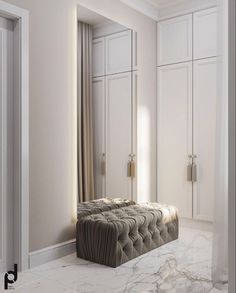 an elegant bedroom with marble flooring and white walls, along with large closets