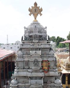 an ornate white and gold statue in the middle of a courtyard