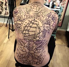 a man with a tattoo on his back