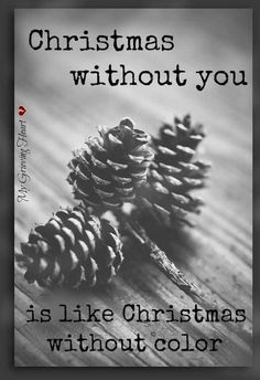 two pine cones sitting next to each other on top of a wooden table with the words, christmas without you is like christmas without color