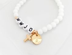 WWJD bead bracelet, What would Jesus do, Religious bracelet, Confirmation gift, Baptism gift, First Communion gift, Christian jewelry MATERIAL*DIMENSIONS*DETAILS Acrylic gum ball beads - 6mm Acrylic letter beads - 7mm Gold Electroplate stainless steel beads and cross charm OPTION MENUS Select bracelet size Select bead color All our jewelry and gifts are custom made and are packaged in complimentary gift boxes. Everything ships in 1-3 business days. Thanks so much for stopping by & God Bless! Homemade Christian Bracelets, Bible Beaded Bracelets, Christian Bead Bracelets Diy, Cute Christian Jewelry, Bible Verse Bracelet Beads, Christian Beaded Jewelry, Gifts For Christian Friends, Wwjd Bracelet Aesthetic, Christan Gifts