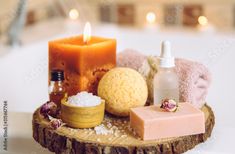 Stock Image: Home spa products on wooden disc tray: bar of soap, bath bomb, aroma bath salt, essential and massage oils, candle burning, rolled towel inside bathroom by tub, water running. Cozy relaxing concept. Candles For Bathtub, Candle Light Bath Tub, Candle Lit Spa, Eucalyptus Radiata, Salt Bath, Easy Fall Decor, How To Roll Towels, Spa Day At Home, Bath Candles