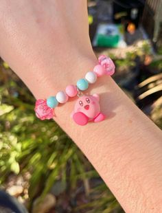 🍭Handmade Kirby-themed charm bracelets!♡ ♡ These bracelets can be fragile and are NOT meant for children and should not be held by the charm. Please keep that in mind while buying :) ♡ If you would like to request a smaller/larger size, send me a message and I will make one for you! ♡ All of the bracelets I make are strung together using elastic cord♡♡ I am not currently doing personalized bracelets, but I may in the future! Thank you for your support Bffs Gifts, Stars Bracelet, Cute Beads, Bracelet Cute, Rose Bleu, Pink Blue Yellow, Personalized Bracelets, Bracelets And Charms, Kirby