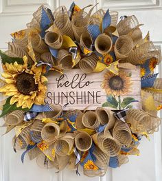 a wreath with sunflowers and the words hello sunshine on it is hanging on a door