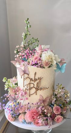 a white cake with pink and blue flowers on top