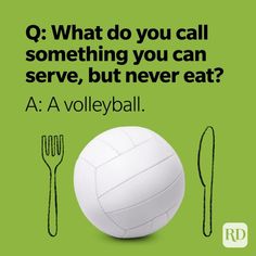 a volleyball ball sitting on top of a table next to utensils and a fork