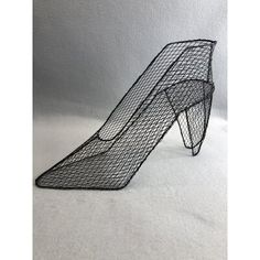 a black wire sculpture sitting on top of a white floor