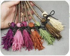 several different colored tassels being held by someone's hand