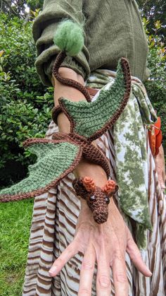 a close up of a person's arm wearing a costume made from crochet