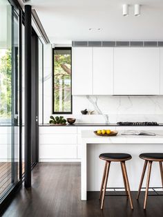 two stools are in front of the kitchen counter