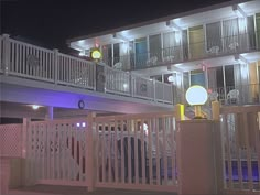 an apartment building lit up at night with lights on the balcony and balconies