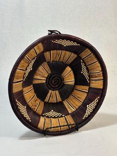 a brown and black basket sitting on top of a white table