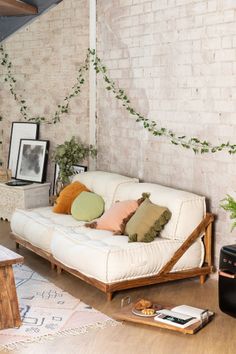 a living room with a white couch and pillows