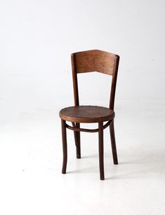 a wooden chair sitting on top of a white floor