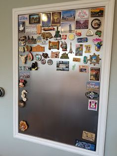 a refrigerator covered in magnets and pictures on the wall next to a toilet bowl