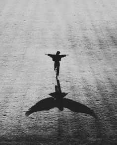 a black and white photo of a person with their arms outstretched