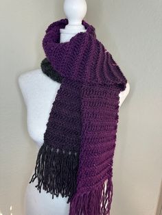 a mannequin wearing a purple and black scarf