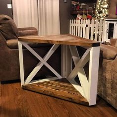 a wooden table sitting on top of a hard wood floor next to a couch and chair