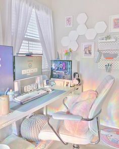 a white desk with a computer on it in a room filled with pictures and other items