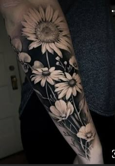 a person with a sunflower tattoo on their arm and the other arm is black and white