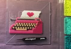 an image of a pink typewriter with hearts on it's screen and other colors