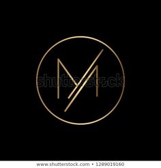 the letter m is inscribed in a gold circle on a black background stock photo edit