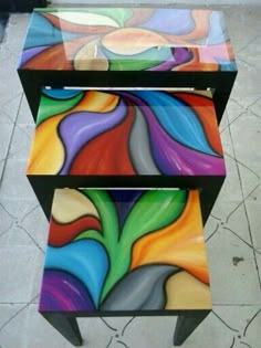 two tables with colorful designs painted on them