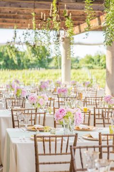 the tables are set with white linens and pink flowers