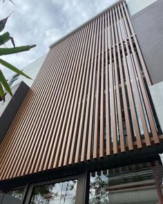 the side of a building with wooden slats on it's sides and windows