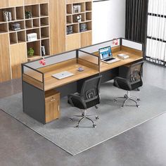 an office cubicle with two desks and chairs