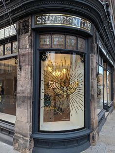 a store front with an ornate glass window