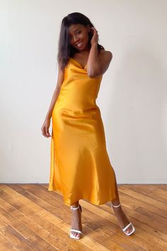 Looking for the perfect classy dress that will have you shining bright at your next event? This gold slip dress outfit offers a touch of glamour for any occasion. Whether you're pairing this look with sneakers for a causal classy look or wearing as a wedding guest look, this champagne slip dress is a stunning choice to show your feminine and classy side. Click the link to shop this product and make a statement at your next special event. Gold V-neck Evening Dress For Summer, Gold V-neck Midi Dress For Evening, Gold Satin Sleeveless Evening Dress, Chic Gold Dress For Gala, Gold Silk Cocktail Dress, Gold V-neck Evening Dress For Cocktail, Glamorous Gold Satin Dress, Chic Gold Slip Dress For Evening, Gold Midi Dress For Gala