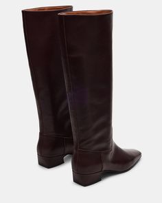 Introducing the GWYNETH square toe boot. These boots offer superior durability and style. Elevate your wardrobe with this versatile footwear option. Perfect for any occasion, the square-toe design provides both comfort and sophistication. 1.5 inch heel height Size 6 measurements: 14.5 inch shaft circumference, 15 inch shaft height Size 8 measurements: 15.5 inch shaft circumference, 15.5 inch shaft height Size 10 measurements: 16.5 inch shaft circumference, 16 inch shaft height Leather upper mate Classic Red Workwear Boots, Classic Square Toe Knee-high Boots For Fall, Classic Calf Leather Knee-high Boots With Square Toe, Classic Wide Calf Knee-high Boots With Square Toe, Classic Knee-high Square Toe Boots With Wide Calf, Classic Knee-high Boots With Wide Calf And Square Toe, Classic Wide Calf Mid-calf Boots With Square Toe, Classic Leather Knee-high Boots With Square Toe, Classic Wide Calf Heeled Boots With Square Toe