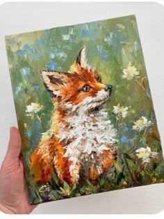 a painting of a little fox sitting in the grass with daisies on it's back