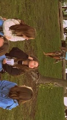 two girls standing next to each other in the grass