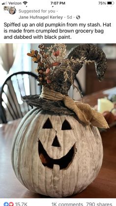 a carved pumpkin sitting on top of a wooden table