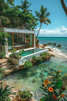 an outdoor swimming pool surrounded by palm trees and water with the ocean in the background