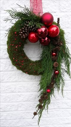 a christmas wreath with ornaments hanging from it