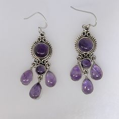 This Is A Lovely Pair Of Amethyst Earrings. Chandelier Style, They Dangle 2.25" With Bale. As Shown In Photos, Amethysts Are A Pleasant Medium Purple Color, Slightly Included But Not Opaque. Cabochons Measure Approximately 6-9mm (Rounds) And 9x7mm Pears. The Earrings Weigh 12.124 Grams. New, No Tags. All Stamped "925". Ess-359 Silver And Purple Earrings, Amethyst Earrings Aesthetic, Purple And Silver Jewelry, Purple Wedding Accessories, Silver Gemstone Chandelier Drop Earrings, Silver Gemstone Drop Chandelier Earrings, Sterling Silver Teardrop Chandelier Earrings With Gemstones, Handmade Purple Sterling Silver Chandelier Earrings, Silver Cabochon Dangle Earrings