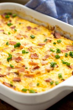 a casserole dish with ham and green onions