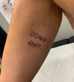 a person with a tattoo that says don't quit