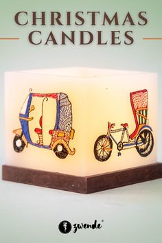 a lit candle with the words christmas candles on it and an image of two bicycles