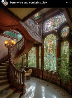 an ornate staircase with stained glass windows and wood railings, along with potted plants