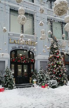 christmas trees and decorations in front of a hotel