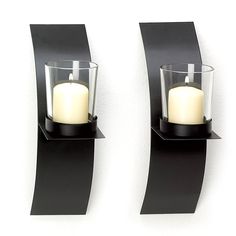 "Get the 8\" Mod-Art Candle Wall Sconce, 2ct. at Michaels. com. The perfect sized accent for your home's wall décor! Made from sturdy glass and metal to create a uniquely ornate home embellishment that is both beautiful and functional. The perfect sized accent for your home's wall décor! Made from sturdy glass and metal to create a uniquely ornate home embellishment that is both beautiful and functional. With a matte black finish, curved metal wall plaques, and a clear glass votive cup this wall Contemporary Candles, Black Sconces, Metal Wall Plaques, Tall Candle Holders, Coloured Candles, Candle Wall, Candle Displays, Wall Candle Holders, Tea Candles