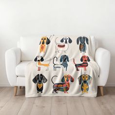 a couch covered in a blanket with dachshunds on it