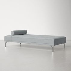 a gray couch sitting on top of a white floor