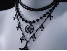 Unveil your dark, mystical allure with our Black Gothic Triple Layered Necklace. The necklace boasts a sophisticated triple-layered design, each chain meticulously crafted to fall at different lengths. The second layer is adorned with a prominent hexagram pendant. Complementing the hexagram, the third layer features cross pendants, embodying gothic influences. Black Mystical Choker Necklace, Mystical Black Choker Necklace, Mystical Style Black Choker Jewelry, Black Gothic Necklace With Chain, Black Gothic Chain Necklace Gift, Black Gothic Jewelry With Clavicle Chain, Gothic Black Jewelry With Clavicle Chain, Black Gothic Clavicle Chain Jewelry, Black Gothic Clavicle Chain Necklace