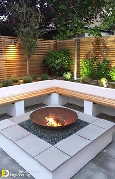 a fire pit sitting on top of a cement block