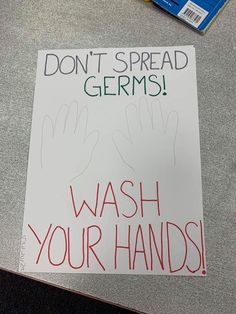 a sign that says don't spread germs wash your hands on it